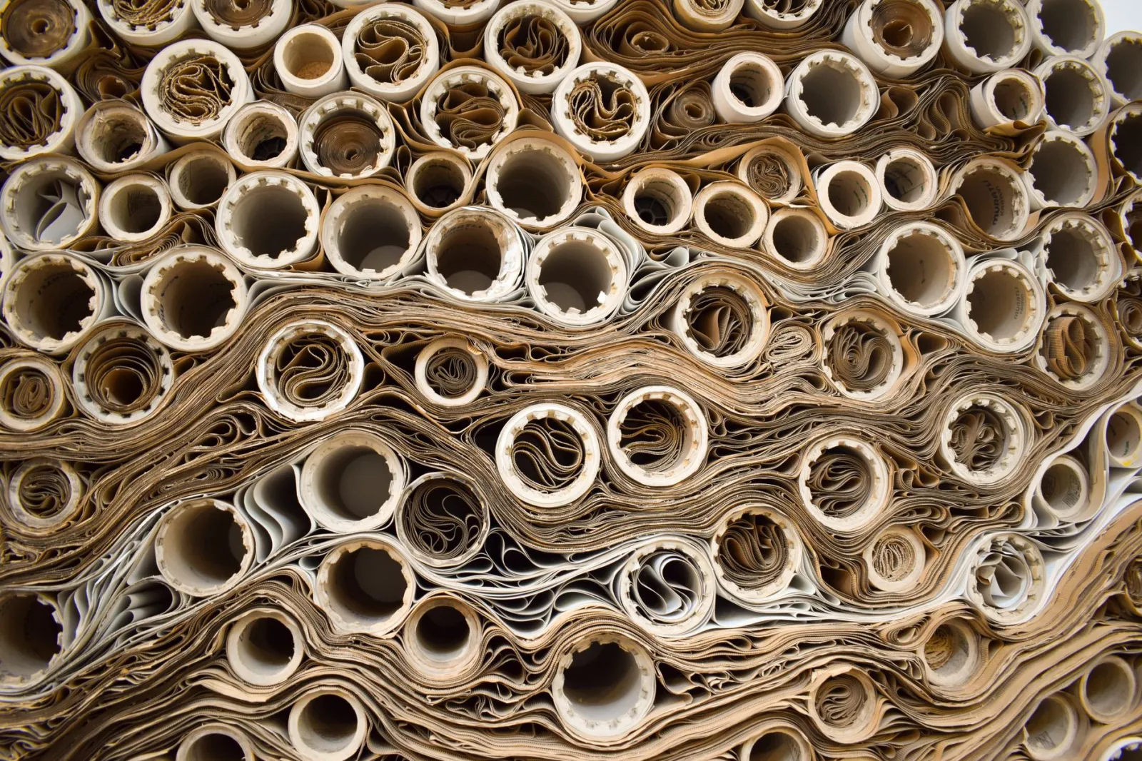 Close-up view of rolled papers creating a complex industrial pattern.